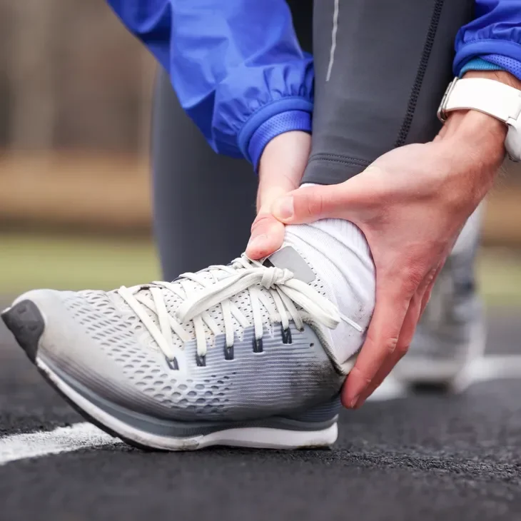 Woman holding a painful ankle